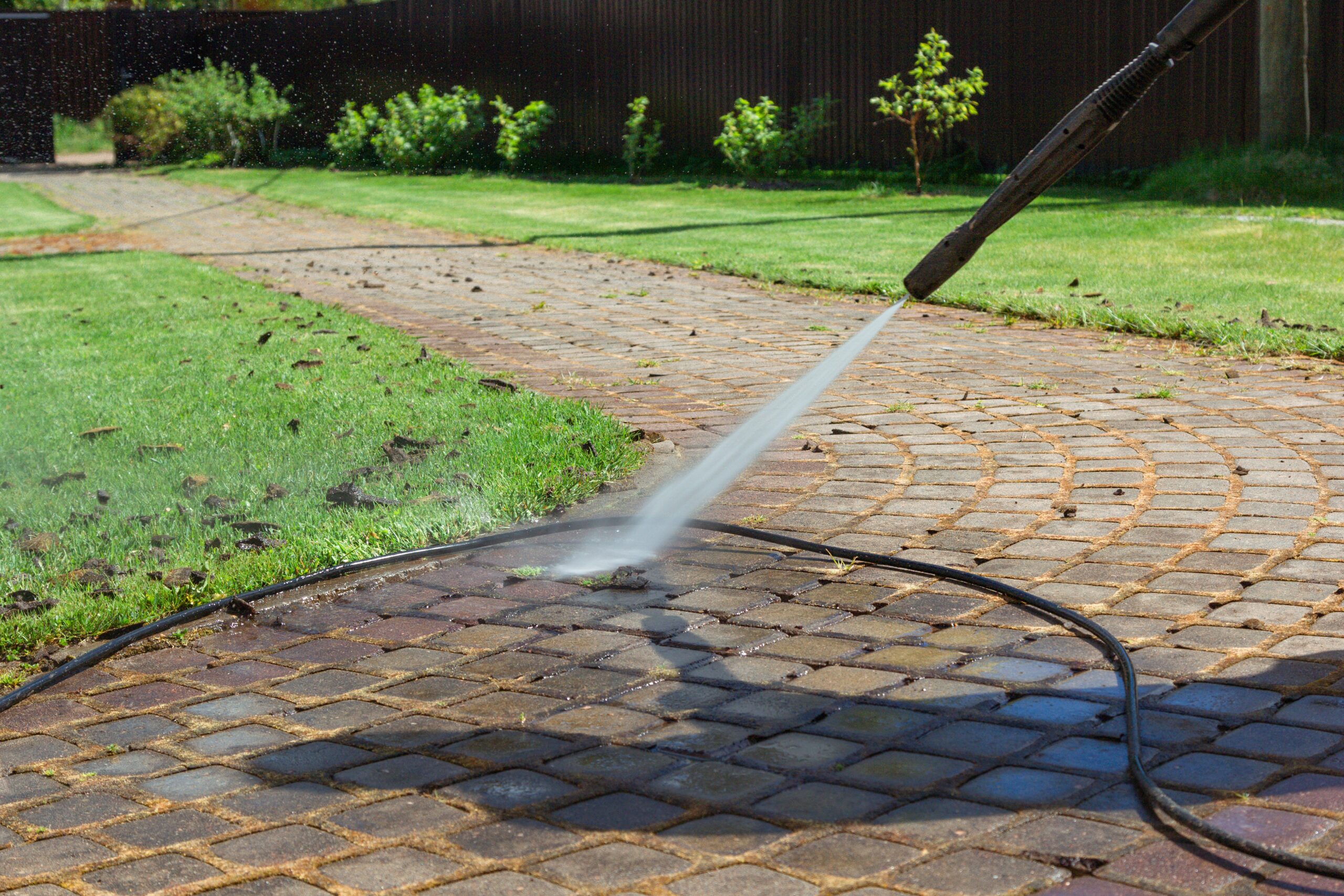 cleaning street with high pressure power washer w 2021 09 02 20 41 06 utc scaled