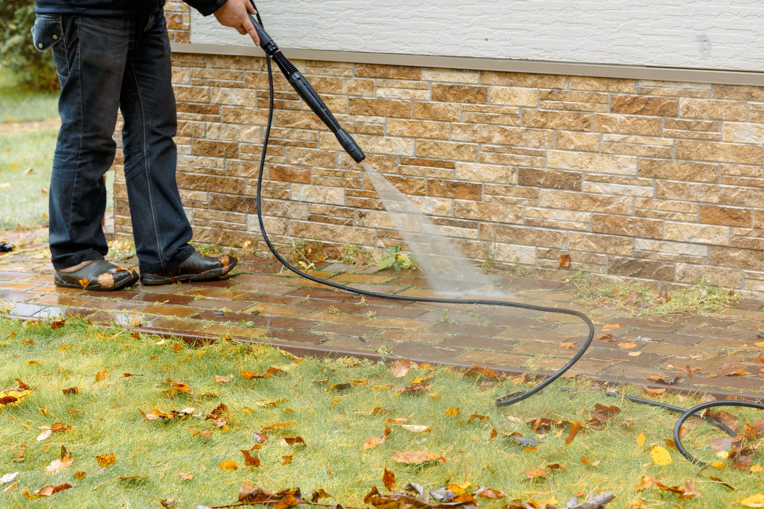 man cleaning street with high pressure power washe 2021 11 07 17 37 54 utc scaled